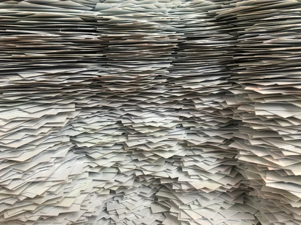 chaotic stacks of paper symbolizing the need for digital data management systems